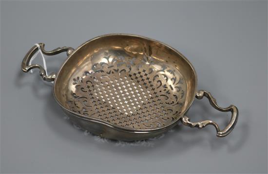 A late 18th century unmarked white metal lemon strainer, 20.8cm.